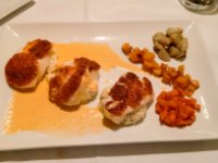 Main course at L&#39;Estaminet; Chilean Sea Bass with a chorizo crust on a bed of risotto with lobster bisque. The vegetables were artichoke cooked in garlic butter on top, pumpkin with cinnamon, and carrots in vanilla on the bottom. I&#39;d never had the vegetables this way but again, the flavours were fantastic! All washed down with a nice glass of bordeaux!